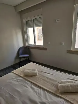 a bedroom with a bed with two towels on it at Oldtown Nightlife 2 in Faro