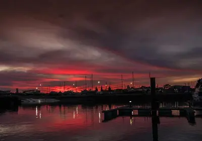 a sunset over a body of water with boats at Vacation Apartment in Vilamoura in Quarteira