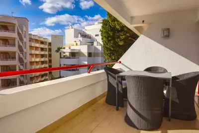 a balcony with a table and chairs on a building at Vacation Apartment in Vilamoura in Quarteira