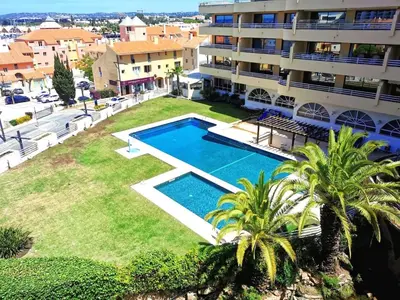 an aerial view of a building with a swimming pool at MarinaMar Vilamoura Sea View in Quarteira