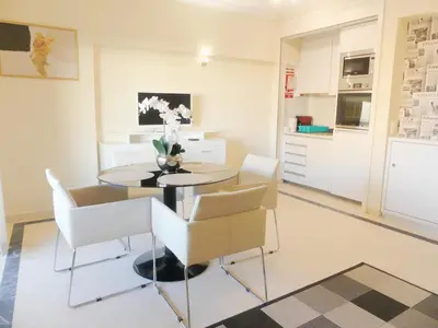 a kitchen and dining room with a table and chairs at MarinaMar Vilamoura Sea View in Quarteira
