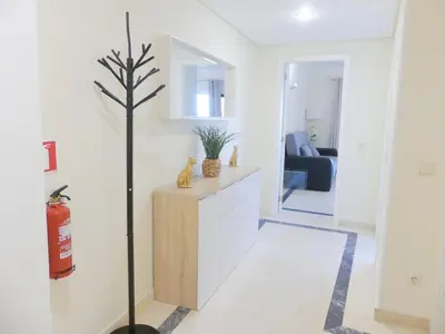a living room with a tree in the middle of a room at MarinaMar Vilamoura Sea View in Quarteira