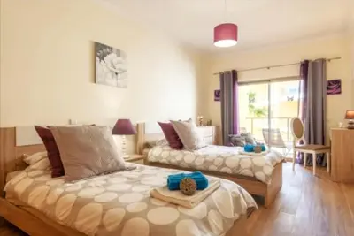 a bedroom with a large bed and a couch at Albufeira Marina Gardens AO in Albufeira