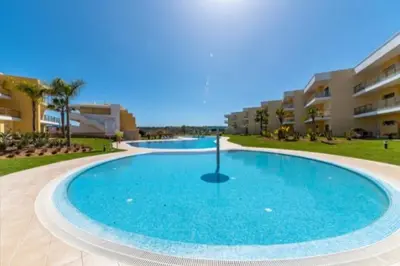 a large swimming pool in the middle of a resort at Albufeira Marina Gardens AO in Albufeira