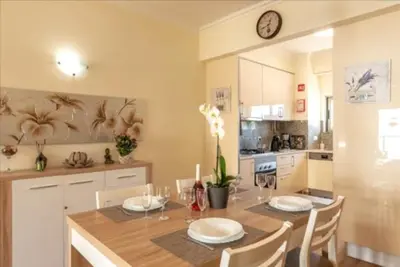 a kitchen with a table and a clock on the wall at Albufeira Marina Gardens AO in Albufeira