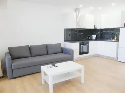 a living room with a couch and a coffee table at Romao Marina Vilamoura in Quarteira