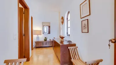 a hallway with a desk and two chairs in a room at Villa Rique in Albufeira