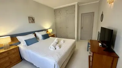 a bedroom with a bed with two towels on it at Apartamento Flor de Amendoeira Mar in Albufeira