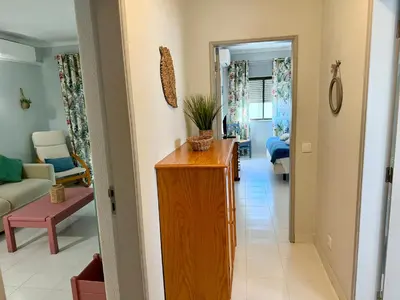 a hallway of a living room with a table at Apartamento Flor de Amendoeira Mar in Albufeira