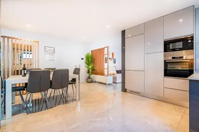 a kitchen and dining room with a table and chairs at Old Town Charm Apartment in Albufeira