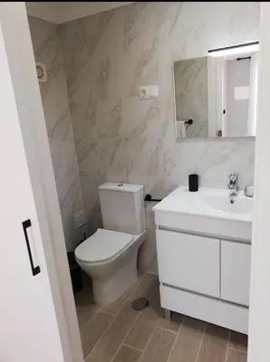 a bathroom with a toilet and a sink and a mirror at Casa Maré Alta in Guia