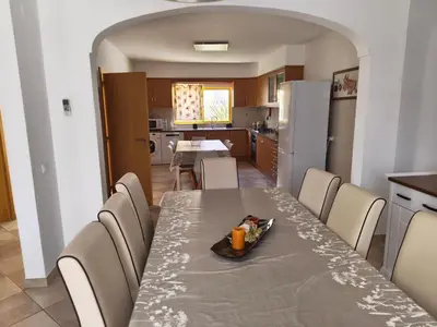 a kitchen and dining room with a table and chairs at Casa Maré Alta in Guia