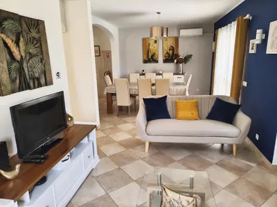 a living room with a couch and a television at Casa Maré Alta in Guia