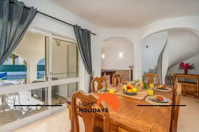 a dining room with a table with a sign that says love holidays at #278 Fonte dos Leoes by Home Holidays in Albufeira