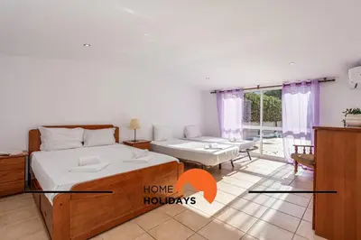 a bedroom with two beds and a living room with a table at #278 Fonte dos Leoes by Home Holidays in Albufeira