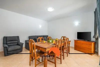 a living room with a table and chairs and a tv at #278 Fonte dos Leoes by Home Holidays in Albufeira
