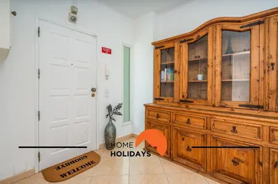 a large wooden cabinet in a room with a door at #278 Fonte dos Leoes by Home Holidays in Albufeira