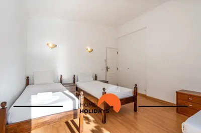 a room with two beds and a mirror at #278 Fonte dos Leoes by Home Holidays in Albufeira
