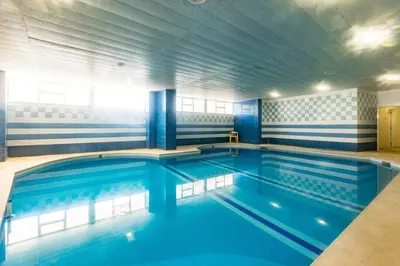 a large swimming pool with blue water at 2 Bed-Sleeps 4-Vilamoura Beach-Pool-Spa-Balcony in Quarteira