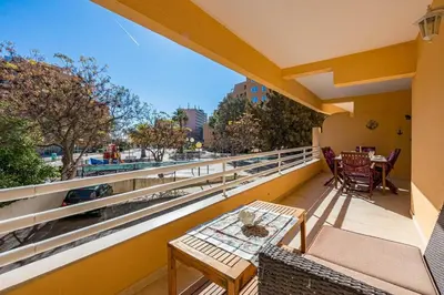 a balcony with a table and chairs and a view at 2 Bed-Sleeps 4-Vilamoura Beach-Pool-Spa-Balcony in Quarteira