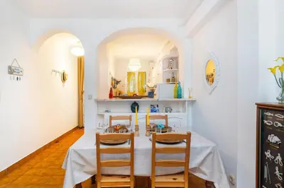 a dining room with a table and two chairs at Sardinha Beach House in Olhos de Água