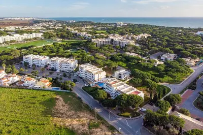 an aerial view of a resort with the ocean at Sardinha Beach House in Olhos de Água
