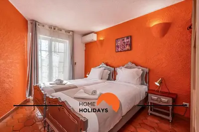 a bedroom with two beds with orange walls at #288 Vivenda 3 Palmeiras 57 by Home Holidays in Albufeira