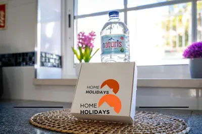 a bottle of water and a box with a sign at #288 Vivenda 3 Palmeiras 57 by Home Holidays in Albufeira