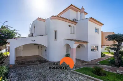 a house with an orange arrow pointing to home holidays at #288 Vivenda 3 Palmeiras 57 by Home Holidays in Albufeira