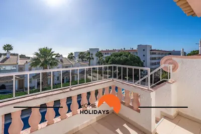 a balcony with a sign that reads love holidays at #288 Vivenda 3 Palmeiras 57 by Home Holidays in Albufeira