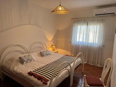 a bedroom with a large white bed in a room at Apartamento Torre da Medronheira in Olhos de Água