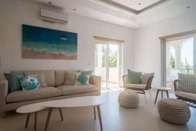 a living room with a couch and a table at Crest 5 - 8 Pax Golf & Beach Swimming pool in Almancil