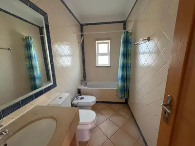 a bathroom with a toilet and a sink and a tub at Old Village Prestige - Vilamoura in Vilamoura