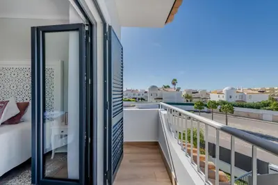 a room with a balcony with a mirror at Casa Maré Viva in Guia