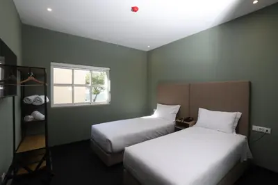 a bedroom with two beds and a window at Albufeira Lounge Hotel in Albufeira