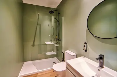 a bathroom with a shower and a toilet and a sink at Albufeira Lounge Hotel in Albufeira