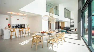 a dining room and kitchen with a table and chairs at Algarve Villa for Contemporary Design & Sea Views in Albufeira