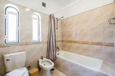 a bathroom with a toilet and a bath tub at Villa Atlantida by Atlantic Places in Albufeira