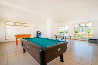 a living room with a pool table in it at Solarium Luxury Apartment by Atlantic Places in Albufeira