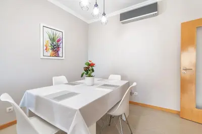 a living room with a couch and a flat screen tv at BnB Homes White Rose Garden Apartment with 2 Terraces & 2 Swimming Pools in Albufeira