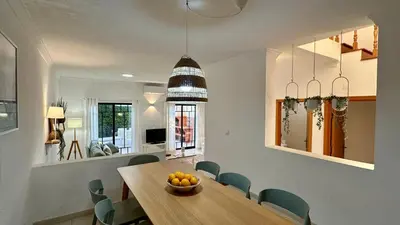 a dining room with a wooden table and chairs at Noly by Check-in Portugal in Albufeira