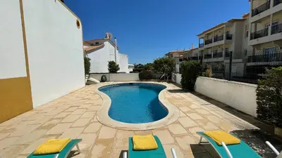 a swimming pool with two lounge chairs and a pair at Noly by Check-in Portugal in Albufeira