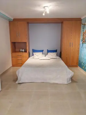 a bedroom with a large bed with blue pillows at Villa Quintaloes, 5 mins from Old Town Albufeira in Albufeira