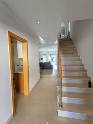 a hallway with a staircase in a house at Villa Quintaloes, 5 mins from Old Town Albufeira in Albufeira