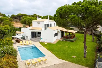 an aerial view of a house with a swimming pool at Villa Oasis 4-Bedroom Retreat with Pool in Vilamoura in Quarteira