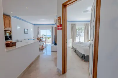 a kitchen and a living room with a bed in a room at Ocean Vista Retreat with Beach & Pool Access by Drago Rentals in Albufeira