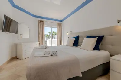 a bedroom with a large bed with towels on it at Ocean Vista Retreat with Beach & Pool Access by Drago Rentals in Albufeira