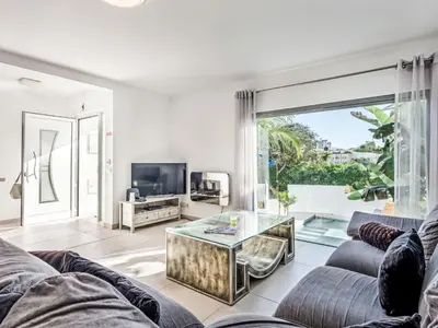 a living room with a couch and a glass table at Holiday Home Praia V5 VIP Properties by Interhome in Vilamoura