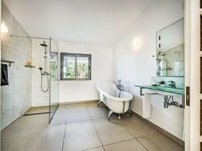 a bathroom with a tub and a glass shower at Holiday Home Praia V5 VIP Properties by Interhome in Vilamoura