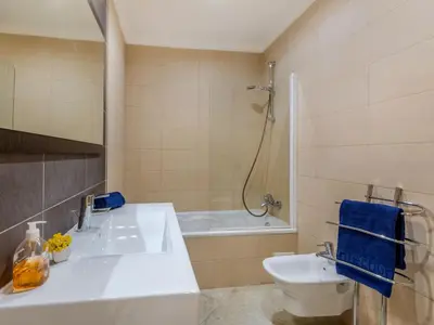 a bathroom with a sink and a tub and a toilet at Holiday Home Encosta dos Salgados by Interhome in Galé